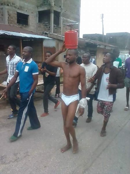 Photos Nigerian Man Who Stole Gas Cylinder In Rivers State Stripped Paraded With It On His
