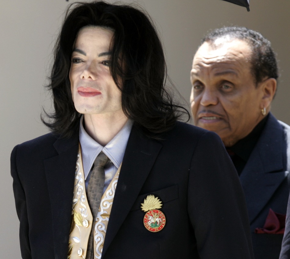 File - Michael Jackson walks with his father Joe, right, after a day of testimony in his child molestation trial in this May 25, 2005 file photo, in Santa Maria, Calif. Jackson, the "King of Pop" who once moonwalked above the music world, died Thursday June 25, 2009 as he prepared for a comeback bid to vanquish nightmare years of sexual scandal and financial calamity. He was 50. (AP Photo/Nick Ut, File)