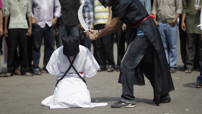 Members of Magic Movement, a group of young Bangladeshis, stage a mock execution scene in protest of Saudi Arabia beheading of eight Bangladeshi workers in front of National Museum in Dhaka October 15, 2011. Eight Bangladeshi migrants have been beheaded in the Saudi Arabian capital Riyadh in public on October 7, as they were sentenced to death for the alleged murder of an Egyptian man in April 2007, an interior ministry of Saudua Arabia statement said. REUTERS/Andrew Biraj (BANGLADESH - Tags: POLITICS CRIME LAW) - RTXXS1D