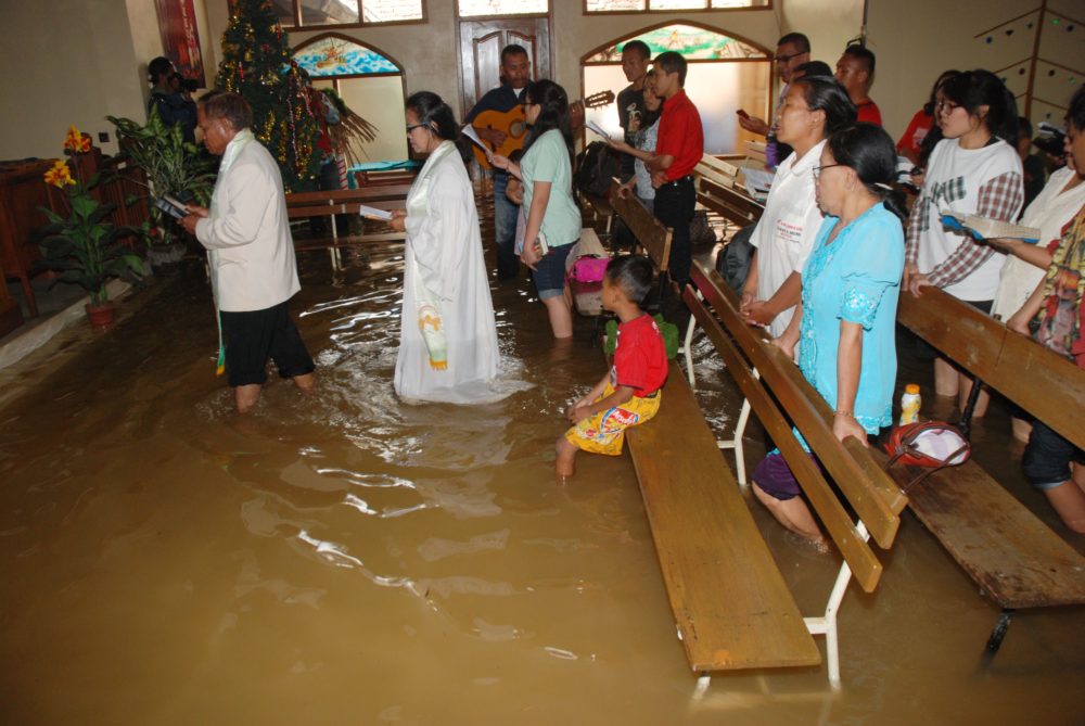 Christians attend the mass service at a flooded church in Bandung, in western Java island, on December 25, 2014. Millions of Christians in Indonesia celebrate the Christmas eve in the most populous Muslim country. TIMUR MATAHARI/AFP/Getty Images